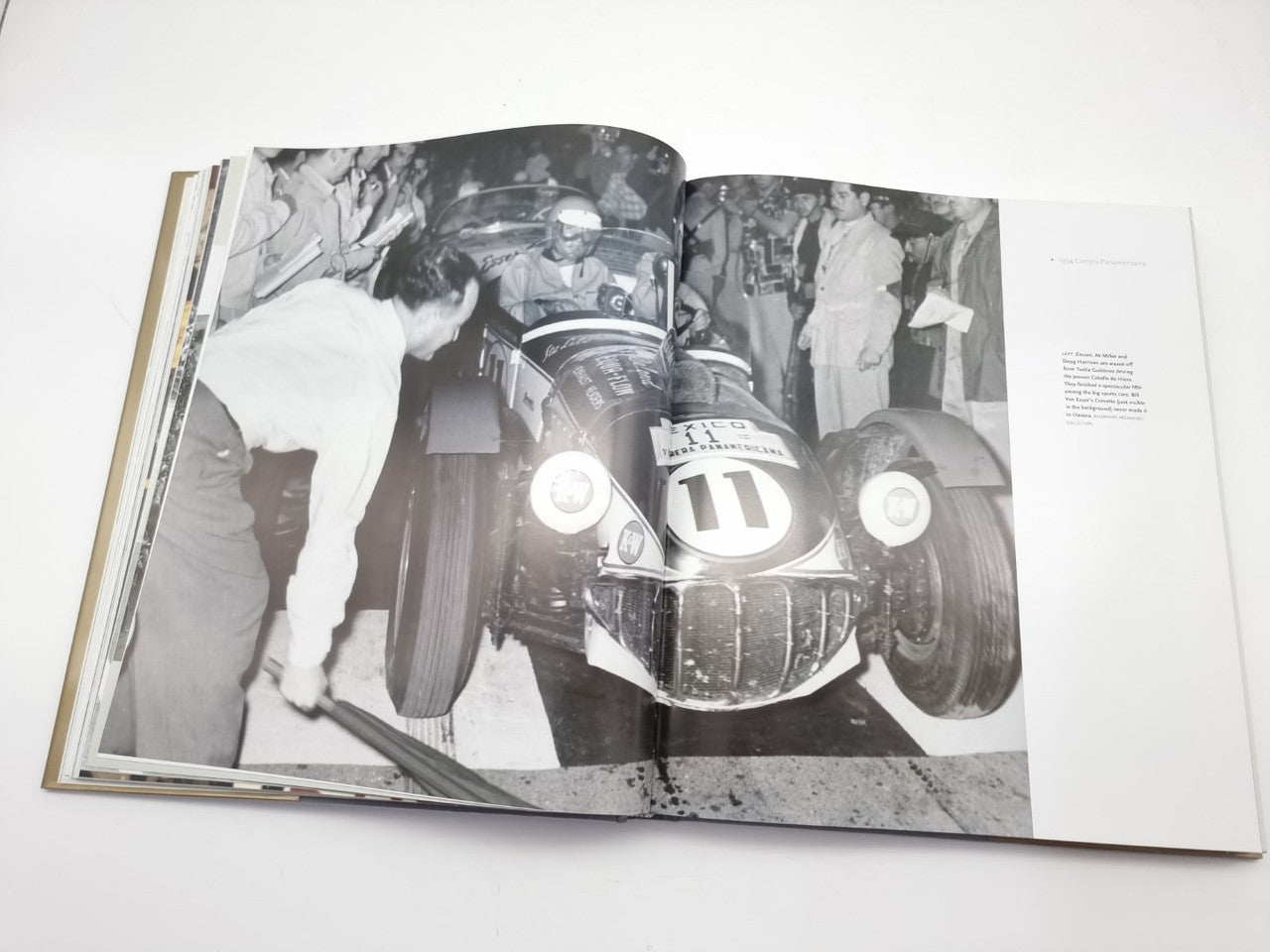 Open book spread featuring close-up vintage race car front with number 11.