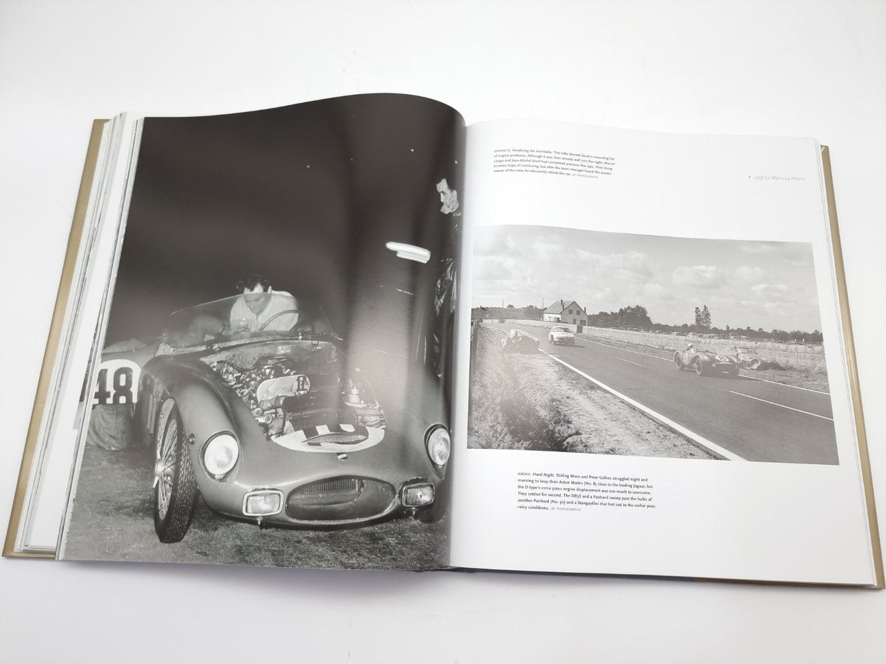 Open book showing classic race car portrait on left and road track photo on right.