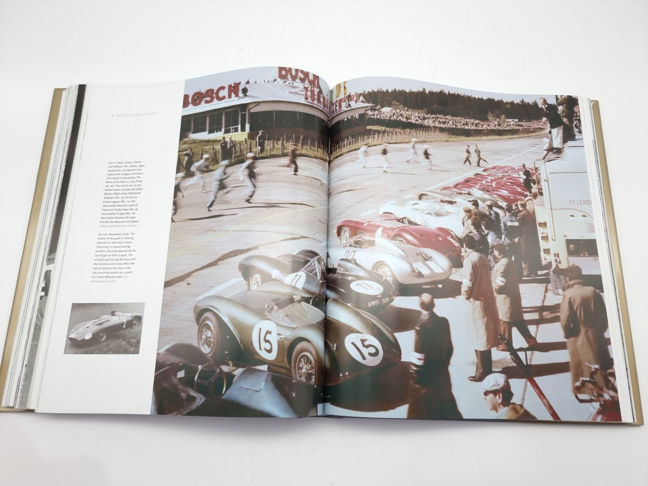 Open book spread with colorful race cars on track and grandstand view.
