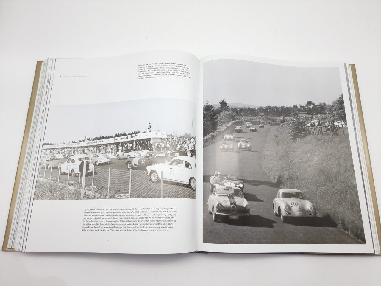 Open book spread with wide aerial view of racetrack and cars.