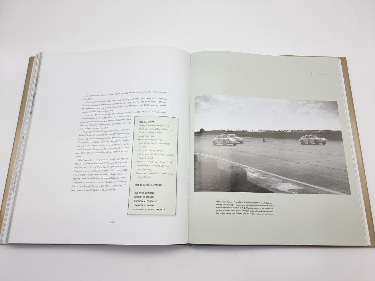 Open book with printed text left page and long racetrack photo right.