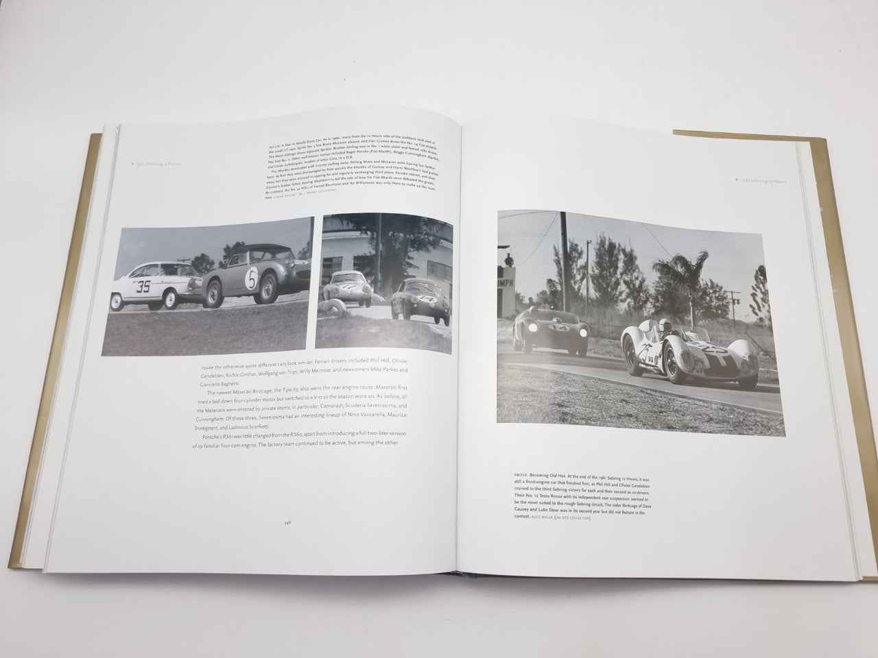 Open hardcover book with color photos of vintage cars on two spread pages
