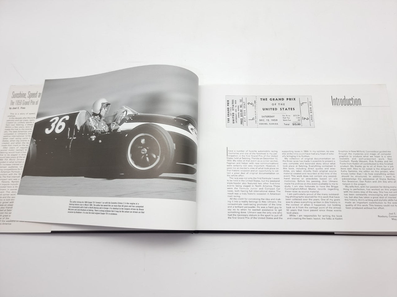 Vintage racing book opened to a split page with black-and-white car photos and text