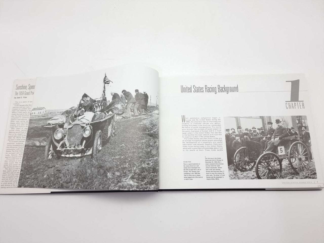 Vintage racing book open to a page with black-and-white race photo and chapter heading