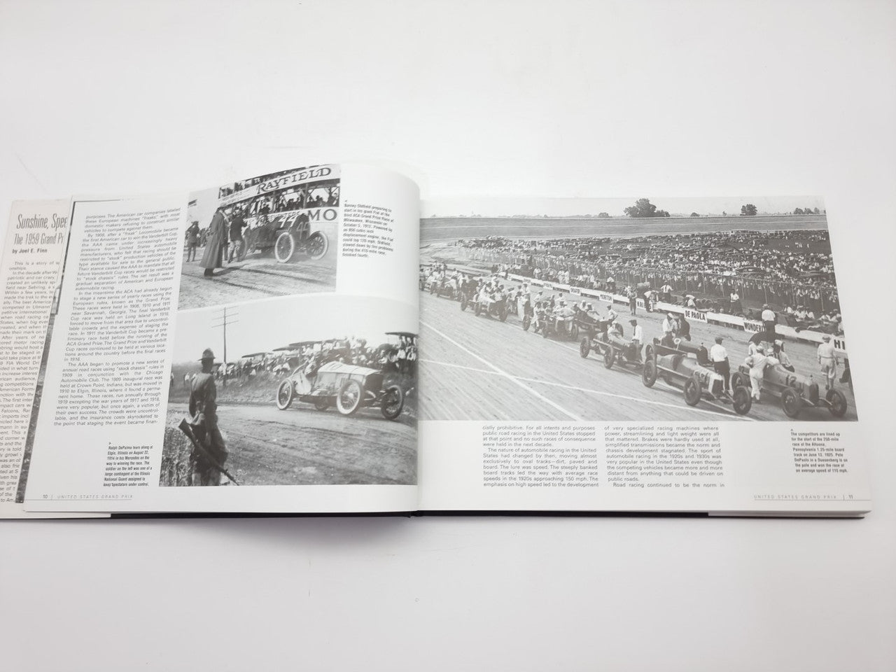 Vintage racing book open with black-and-white track photos and surrounding article text
