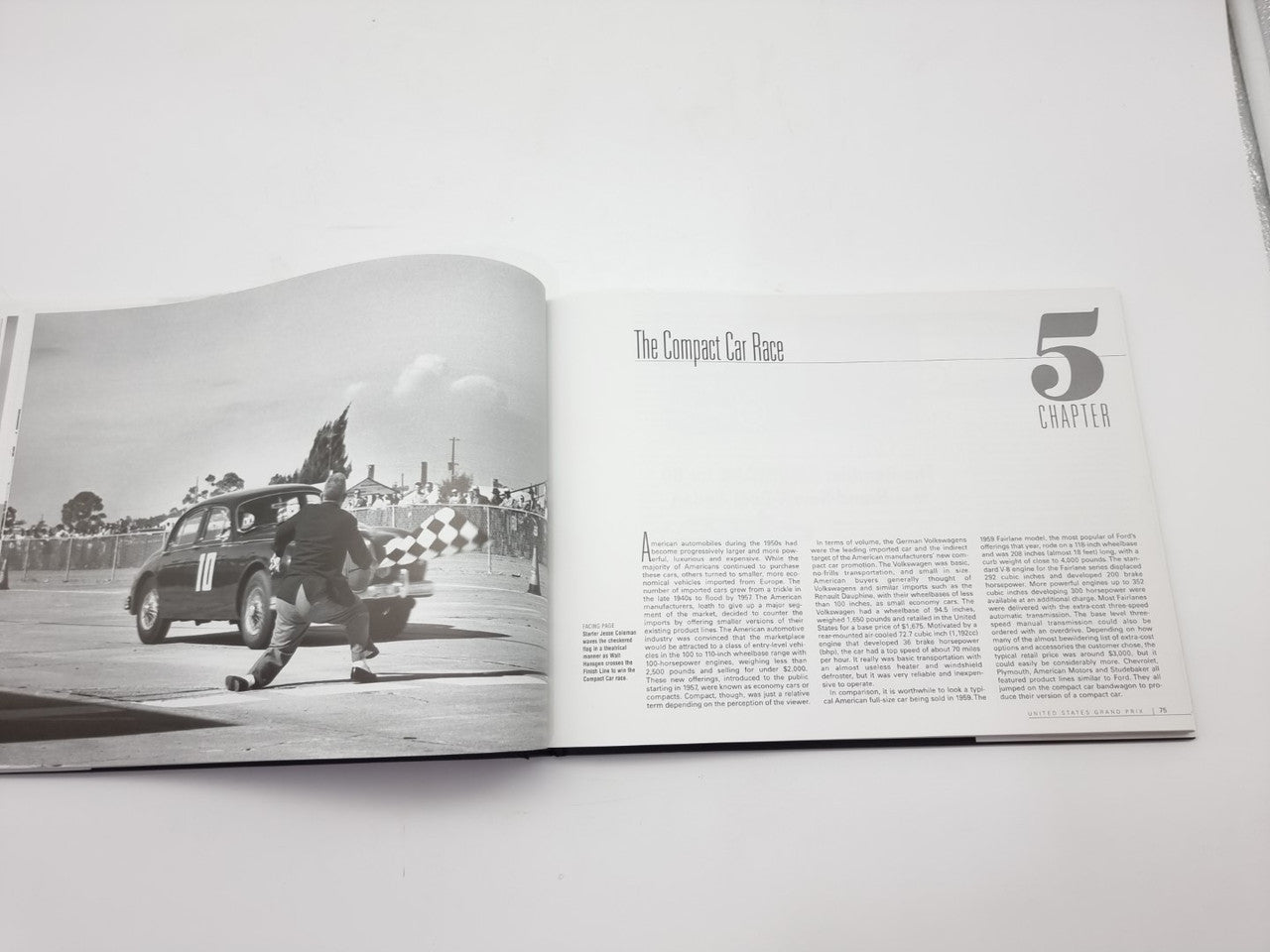 Vintage racing book open with a checkered track car photo and chapter heading 5