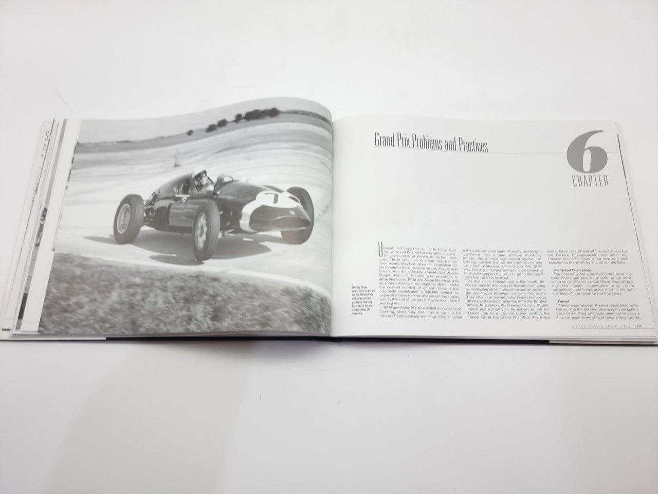 Open racing book chapter page with car photo and printed article text