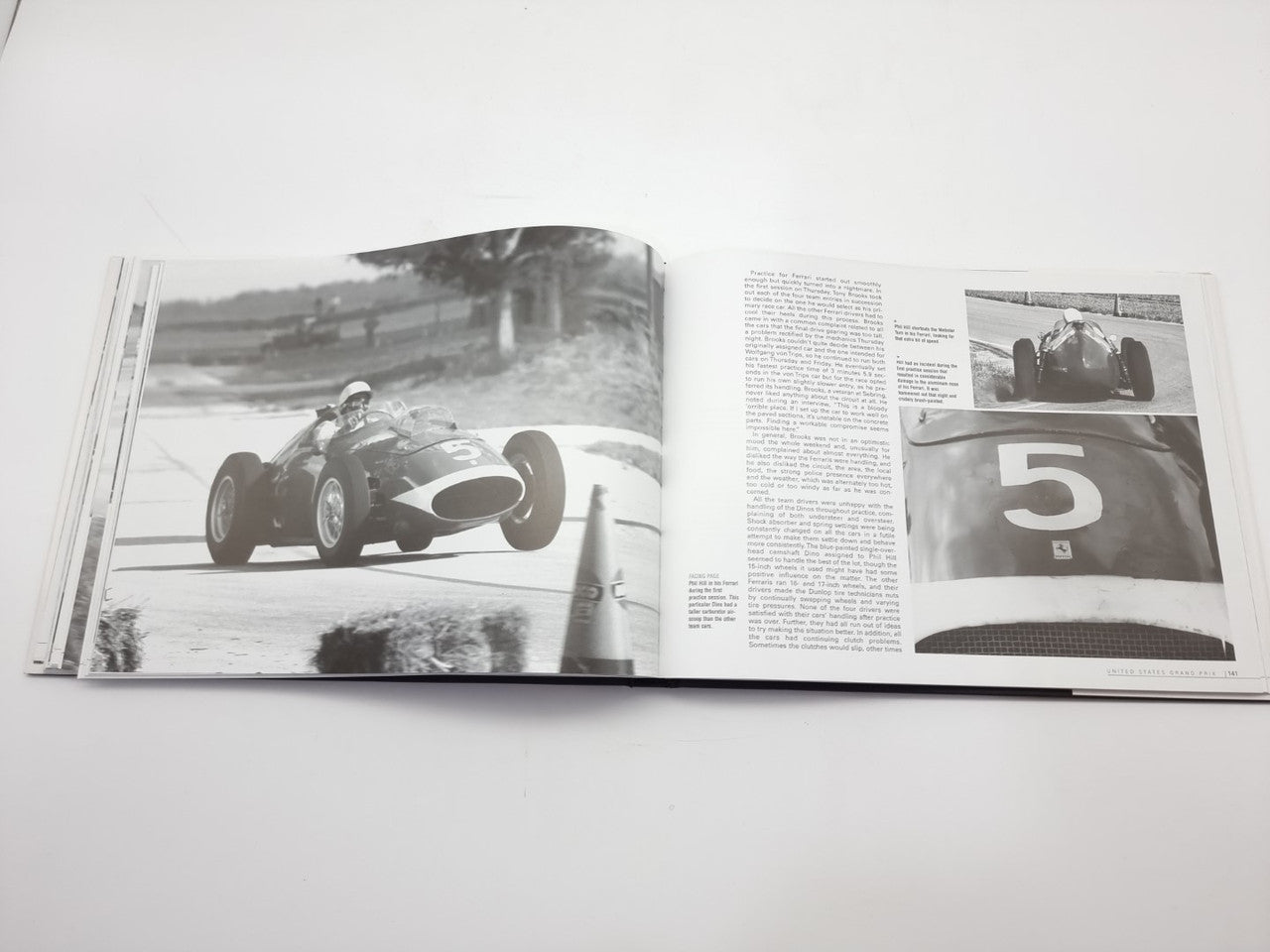 Vintage racing book open with two black-and-white track photos and paragraph text