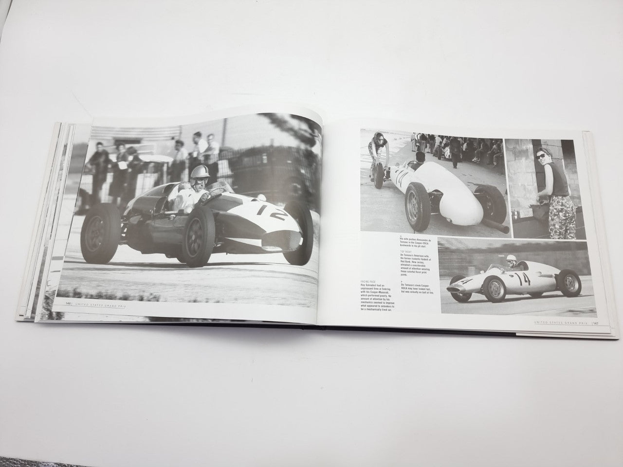Open racing book spread with vintage race car photos and captions