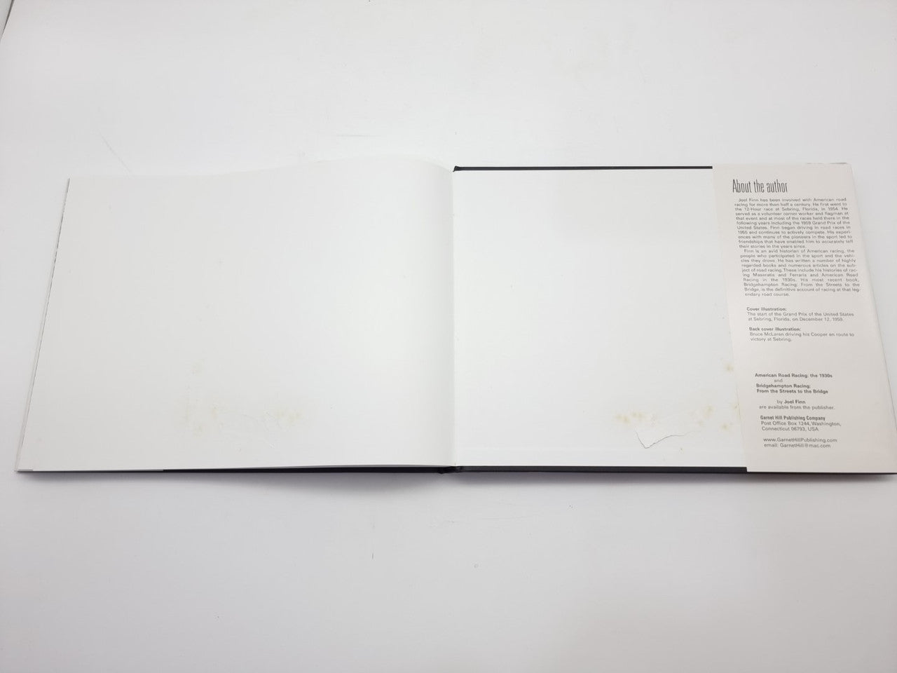 Open racing book spread with blank left page and right text section