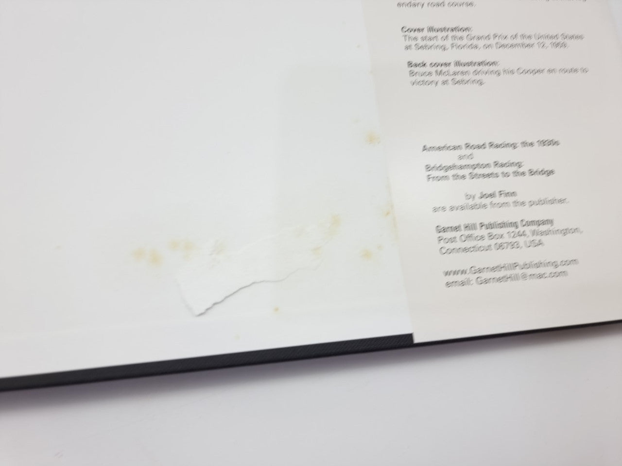 Open racing book page with printed text, viewed from the side
