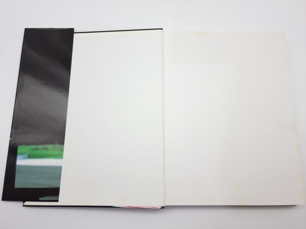 Ferrari F1 victories book, open spread with blank pages and black page edges