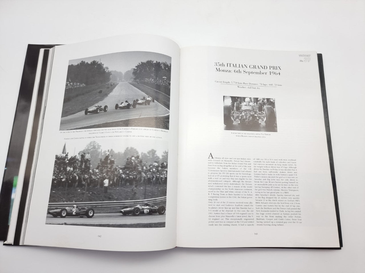 Open motorsport book with road-race photo spread and article text on the right page