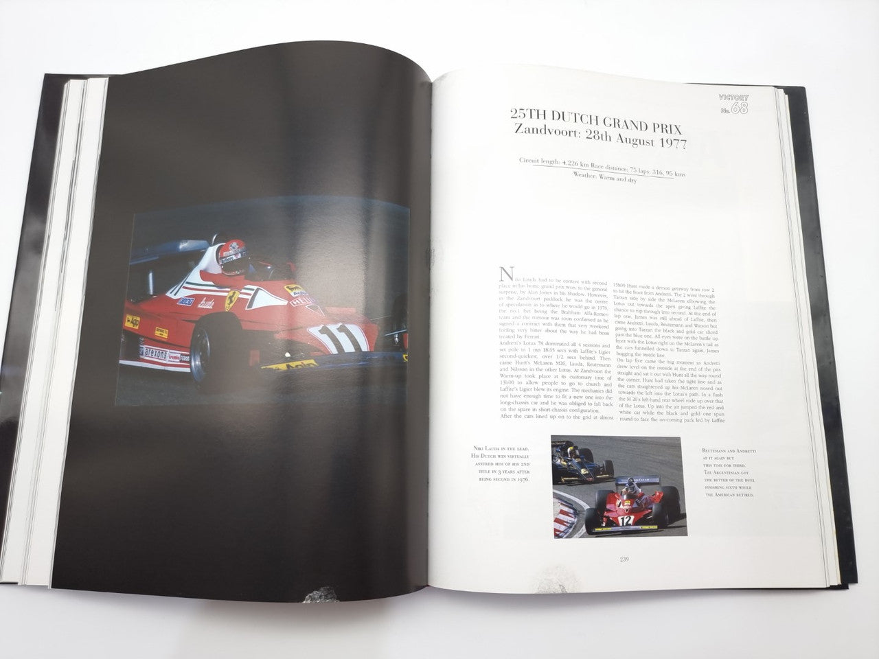 Open motorsport book with a red race car photo and printed race report text