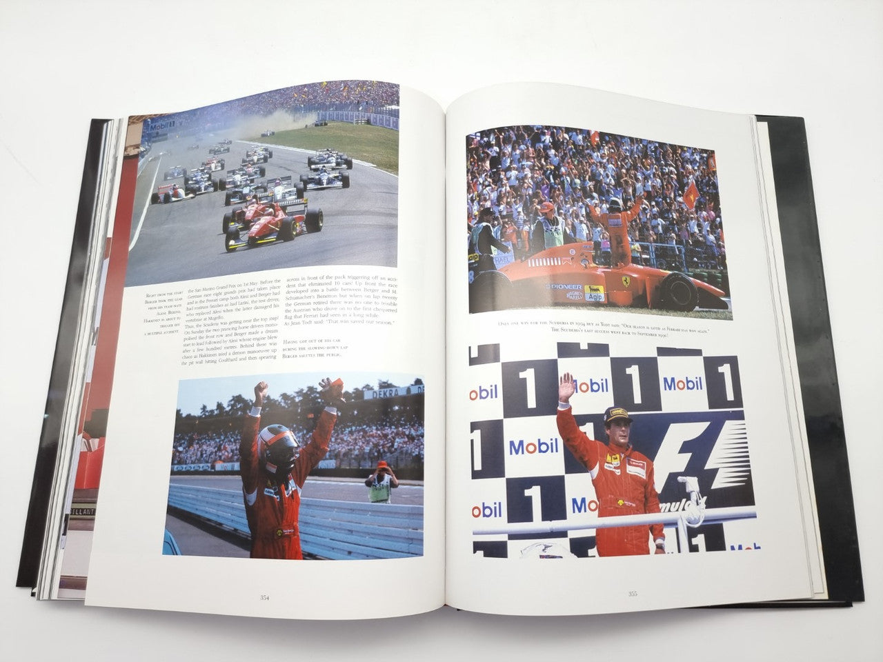 Open motorsport book with crowd photos and a two-page podium celebration image