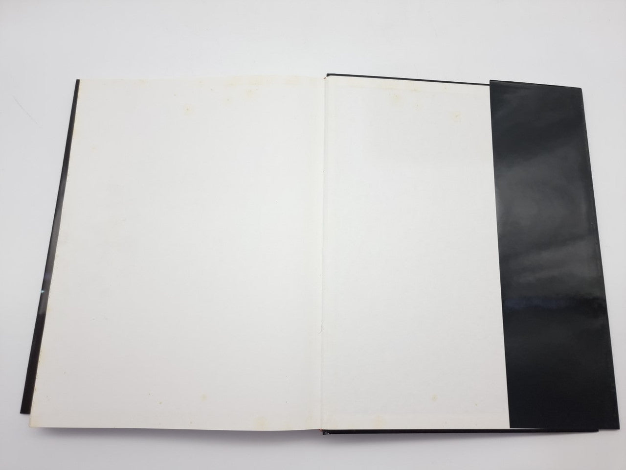 Ferrari F1 victories book, open blank pages with dark right-side cover