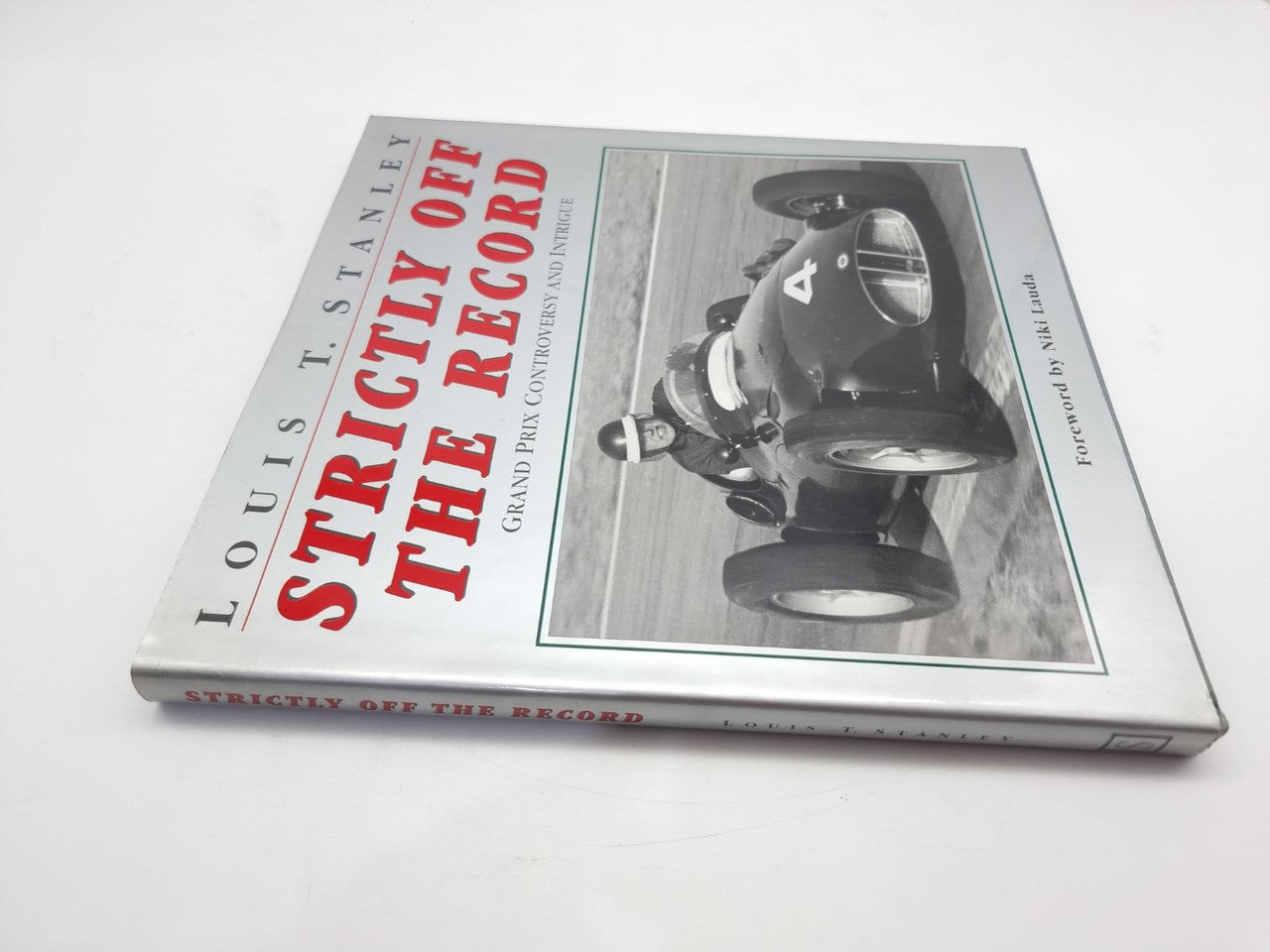 Racing history book shown from the side with cover title and car photo