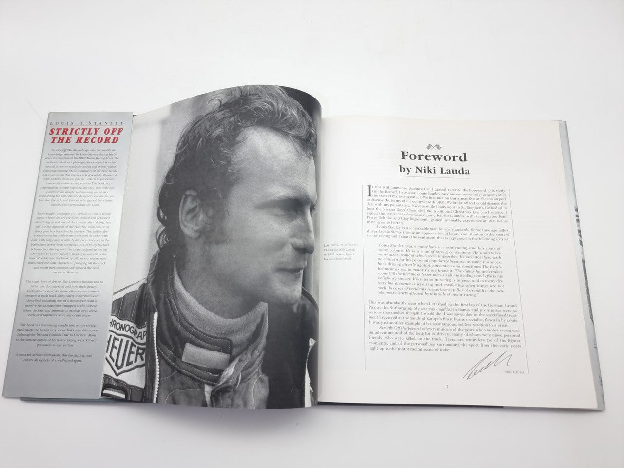 Racing history book open with a portrait photo and the forward page