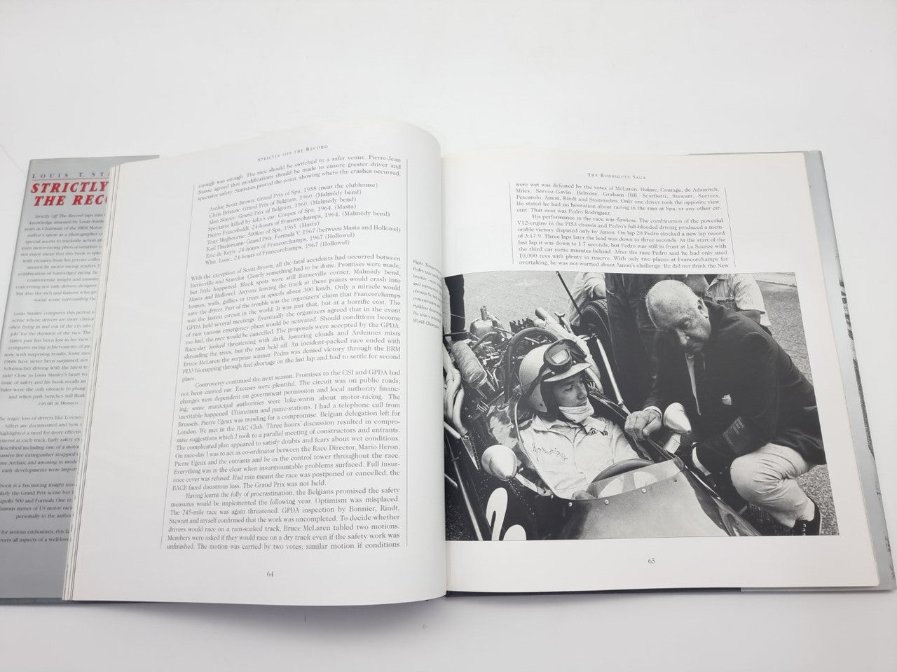 Open book showing racing photo on right page and printed article text