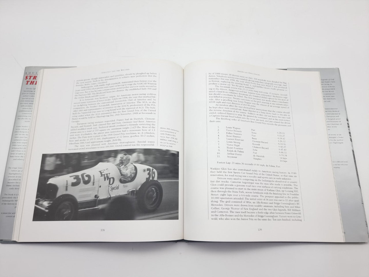 Open book with black-and-white race car photo and full printed text pages