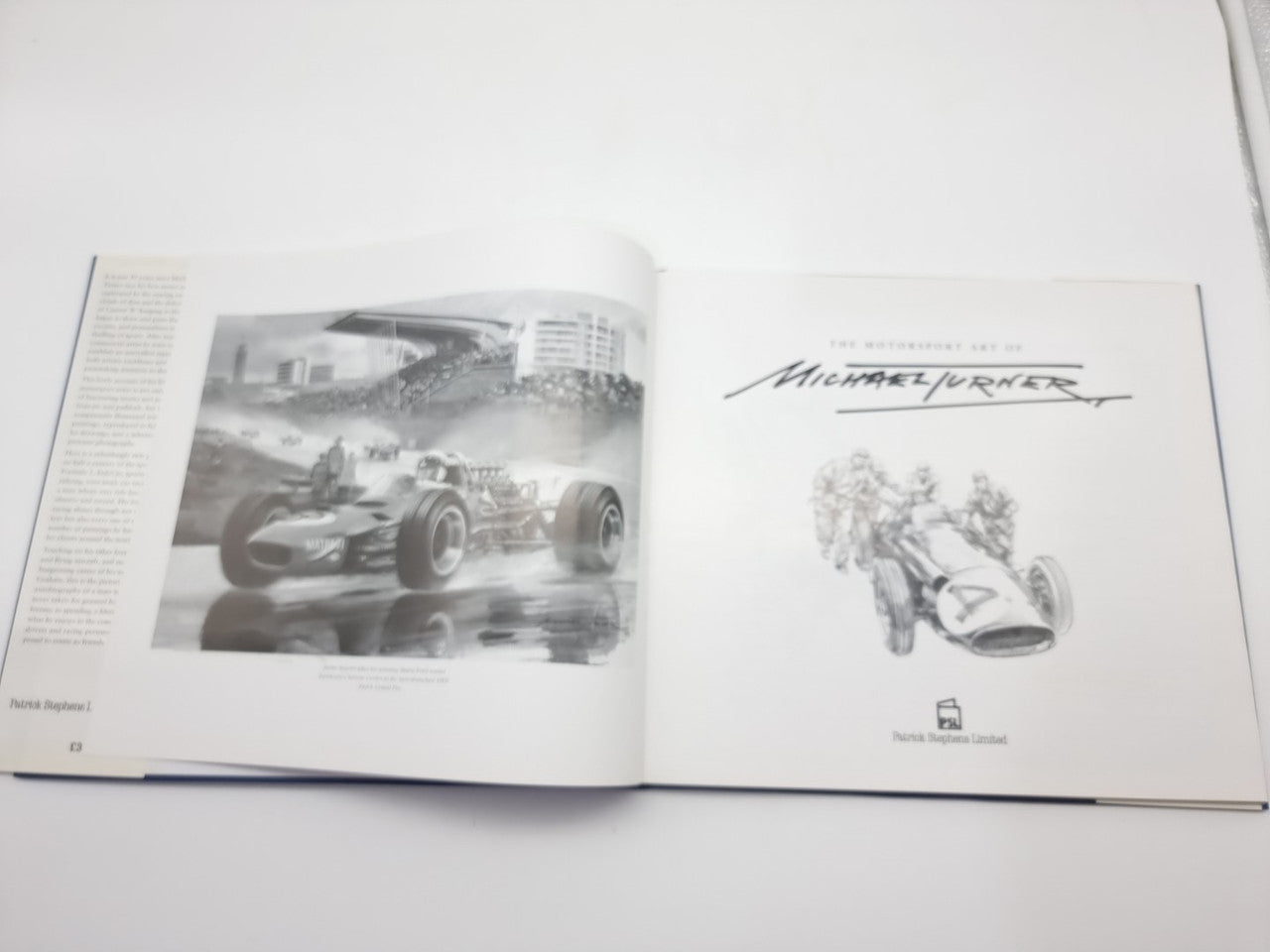 Open motorsport art book page spread with black-and-white race car images