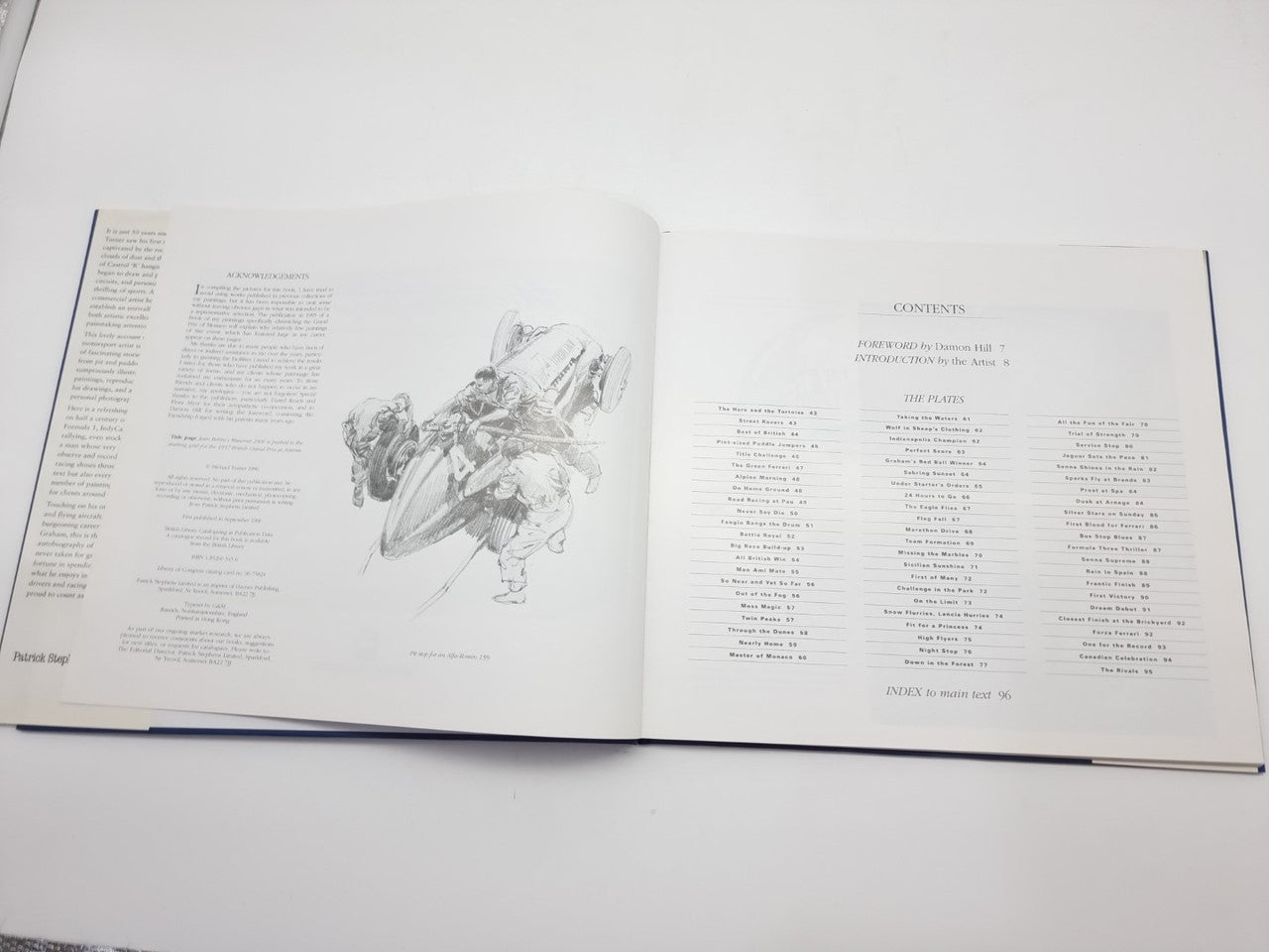 Open motorsport art book spread with line drawing of a race car and text
