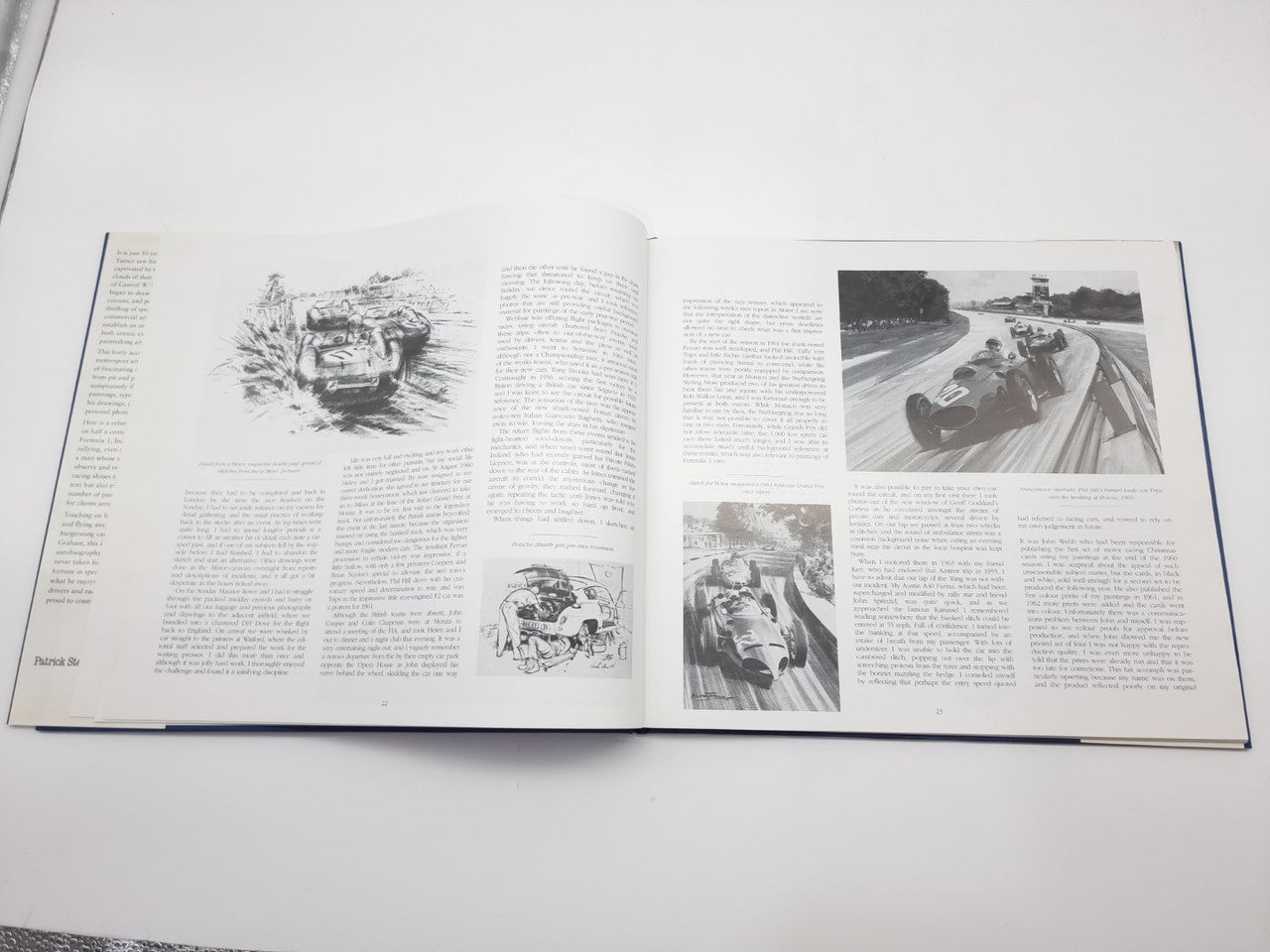 Open motorsport art book pages with ink sketches and small race photo insets