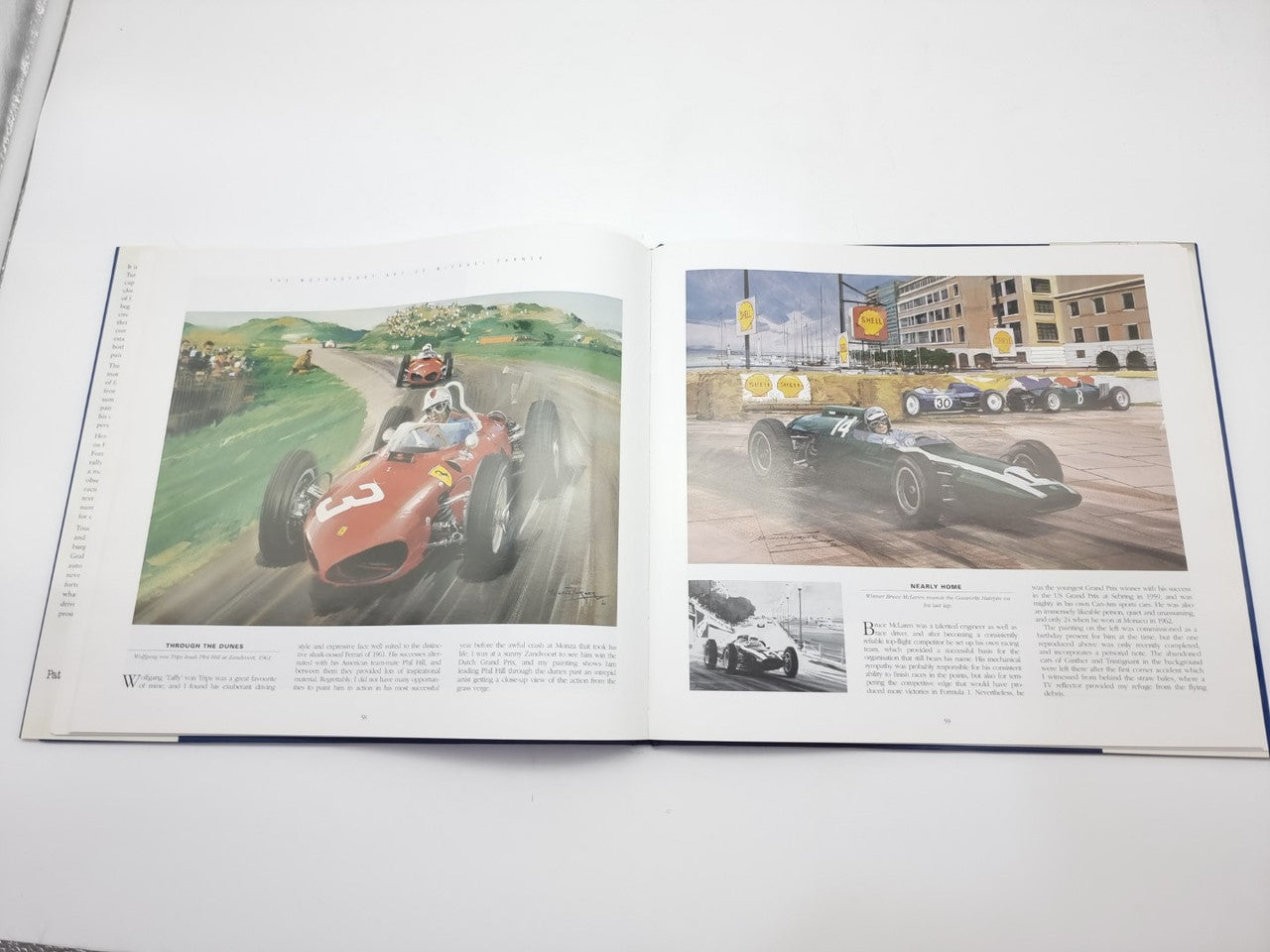 Open motorsport art book spread featuring color race car images on pages