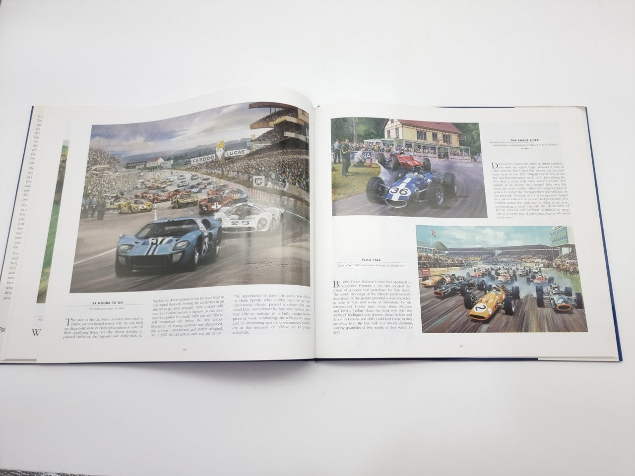 Open motorsport art book spread with multiple color photographs of race cars