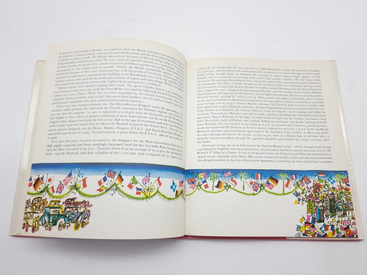 Open vintage illustrated book with large text blocks and colorful border beneath.