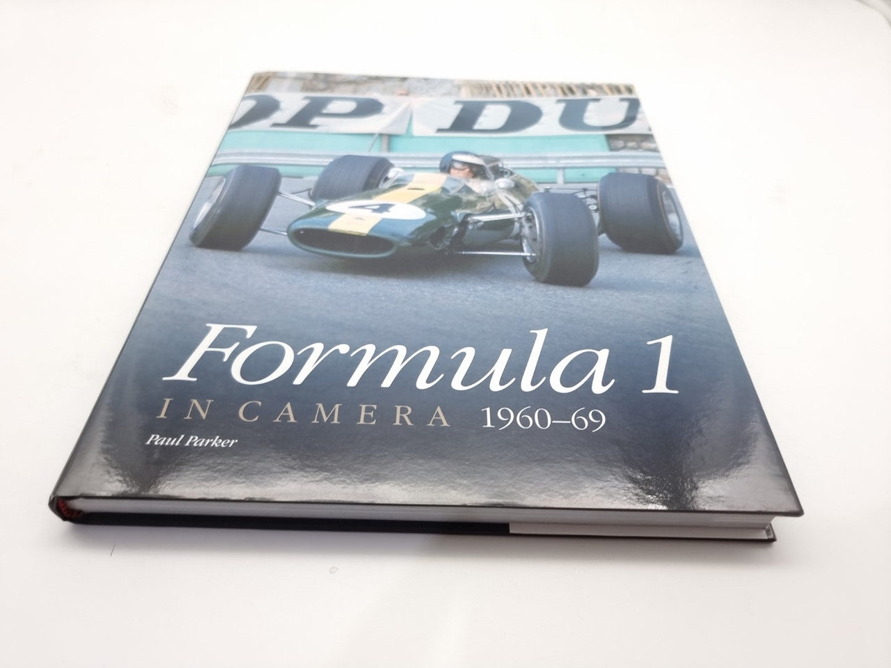Motorsport photo book cover with Formula 1 text and a race car on the front