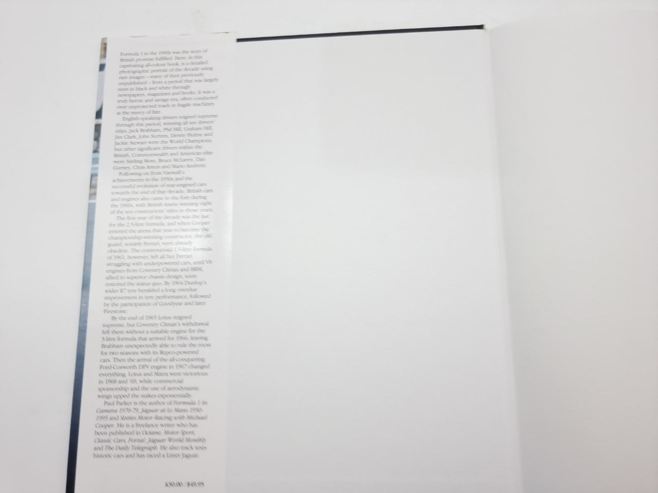 Hardcover photo book open to text pages, with page gutters and header line