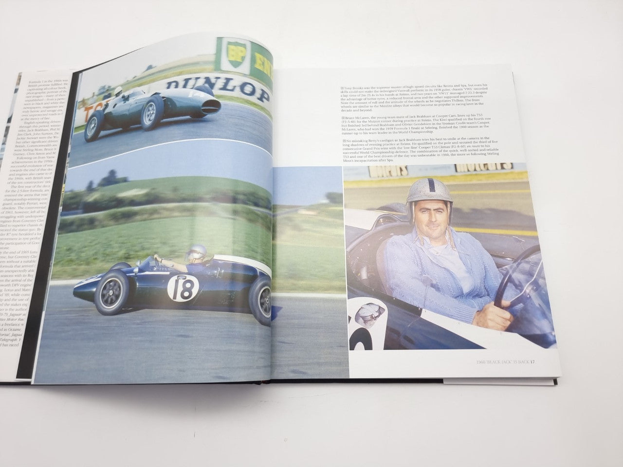 Photo book open to racing car images and a driver portrait on the right