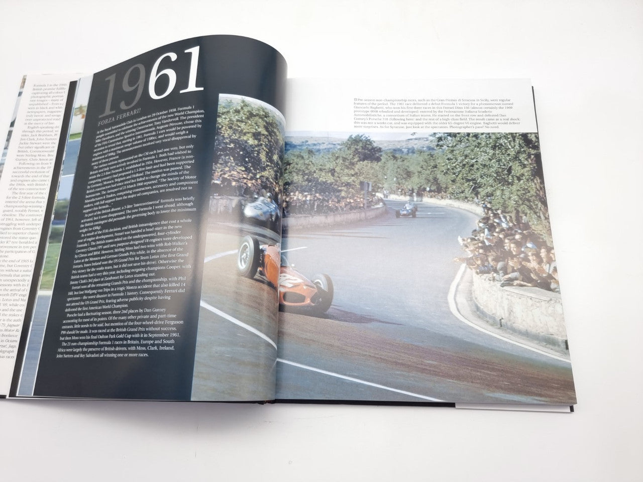 Photo book open to a left page labeled “1961” and a color track photo on right