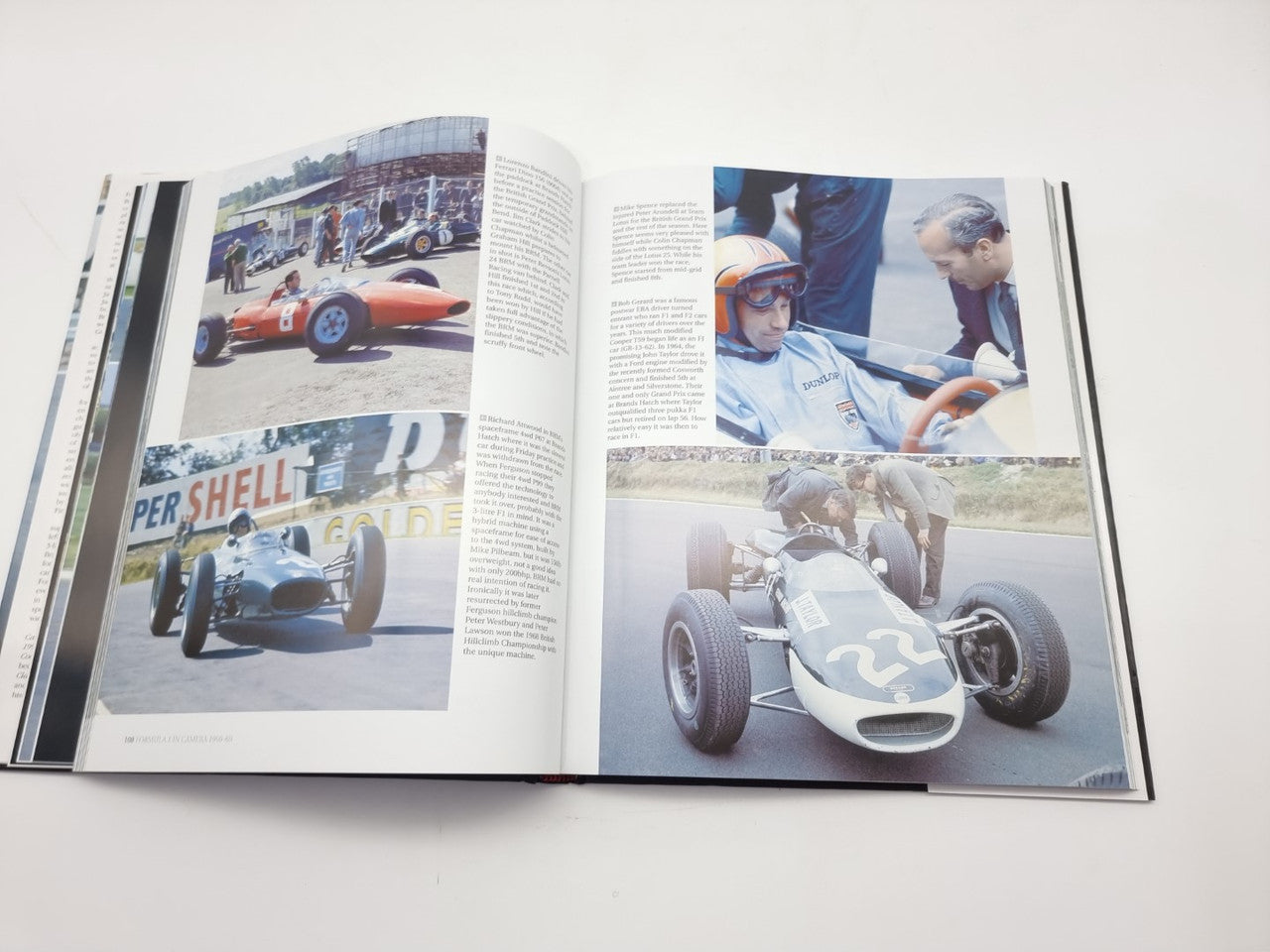 Open photo book with two color race photos across the spread and caption text