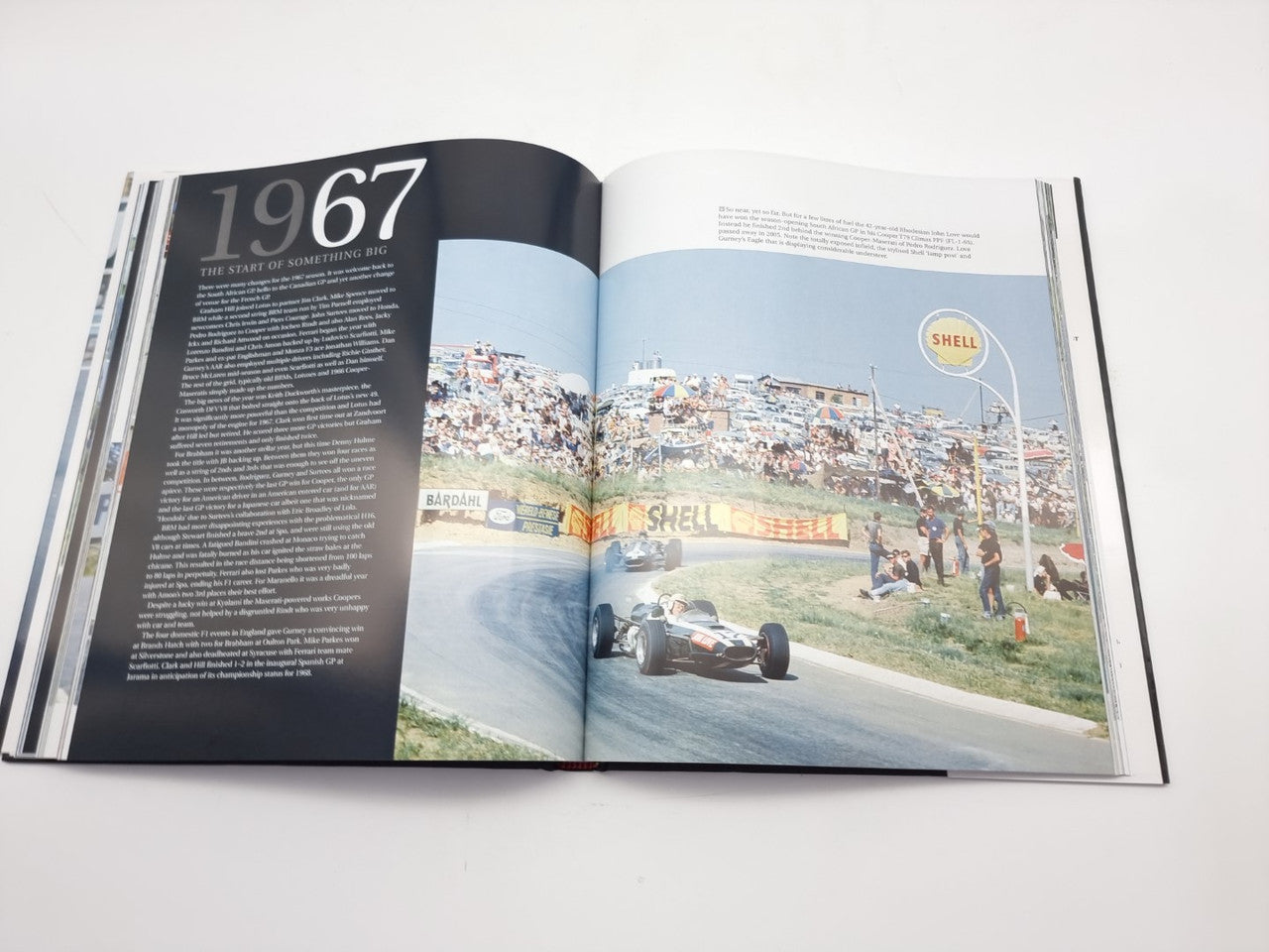 Photo book spread with “1967” on the left page and a crowded grandstand track photo