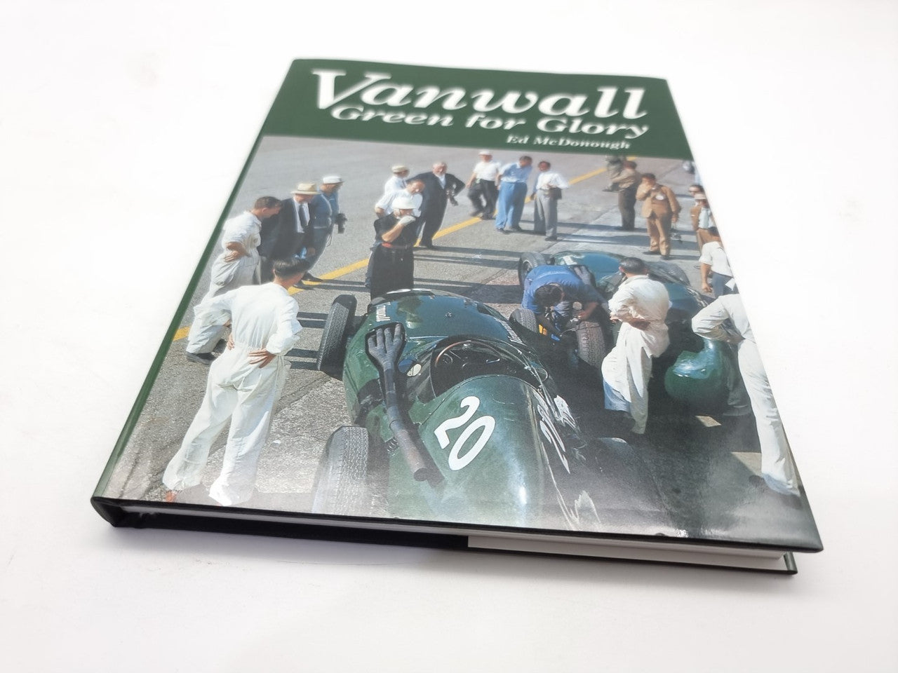 Motorsport book with green cover, Vanwall title, and race car photo montage