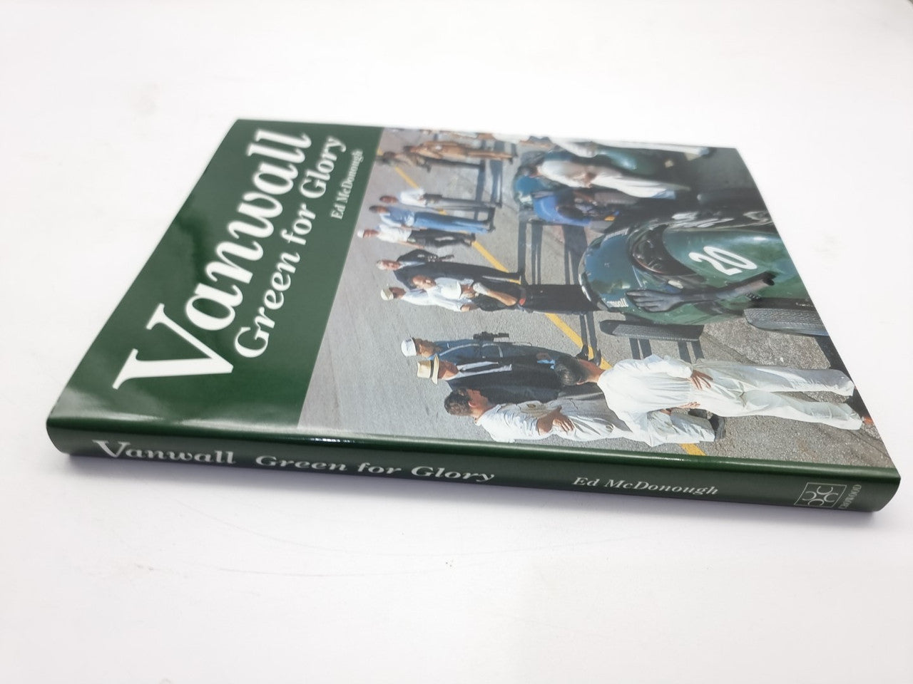 Motorsport book with green cover, Vanwall title, and race car action photo