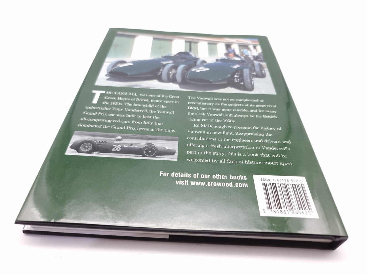 Motorsport book back cover with green panel, race car photo, and barcode