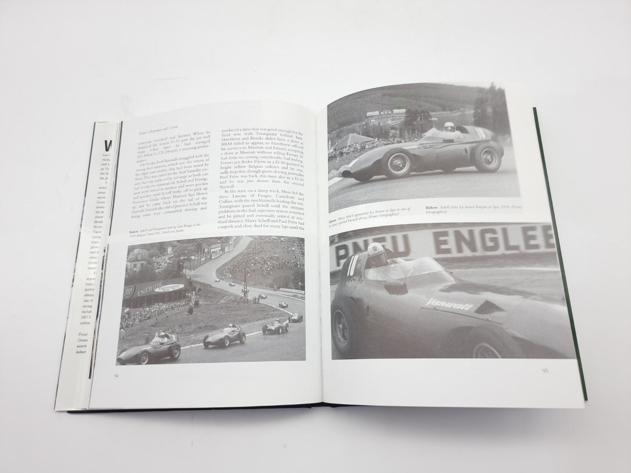 Open motorsport book with black-and-white race photos and paragraphs of text