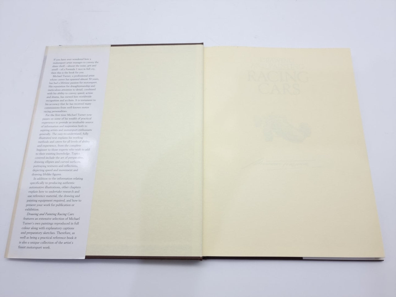Racing cars drawing and painting book open to blank pages