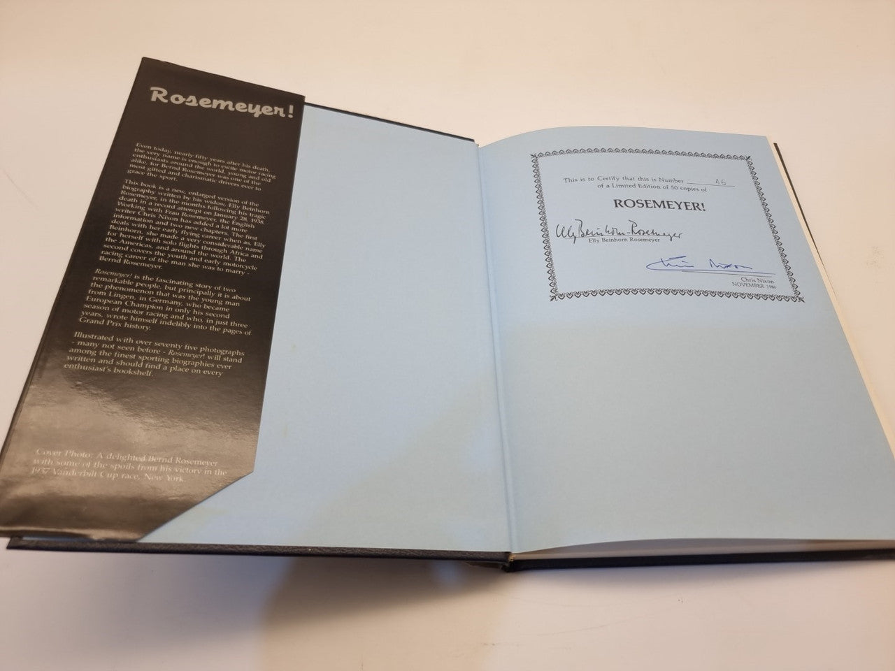 Open biography book with printed text page on left and title page on right