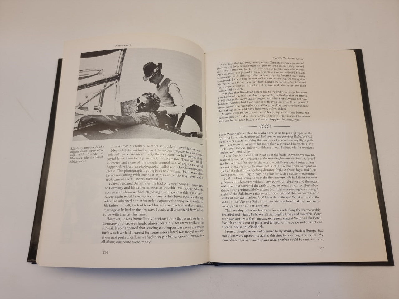 Open biography book with two text columns and black-and-white photo panels