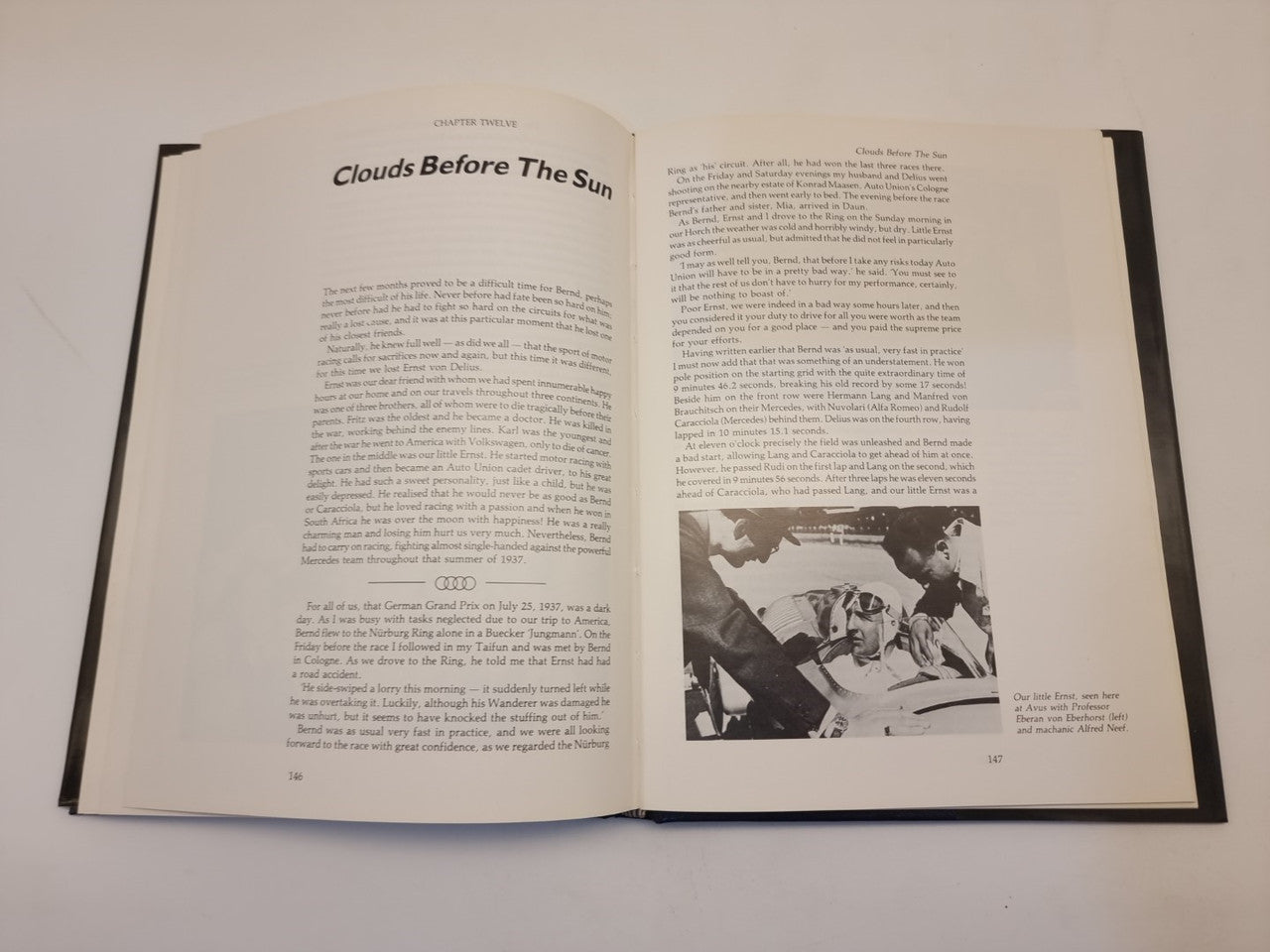 Open biography book with 'Clouds Before The Sun' heading and photo inset