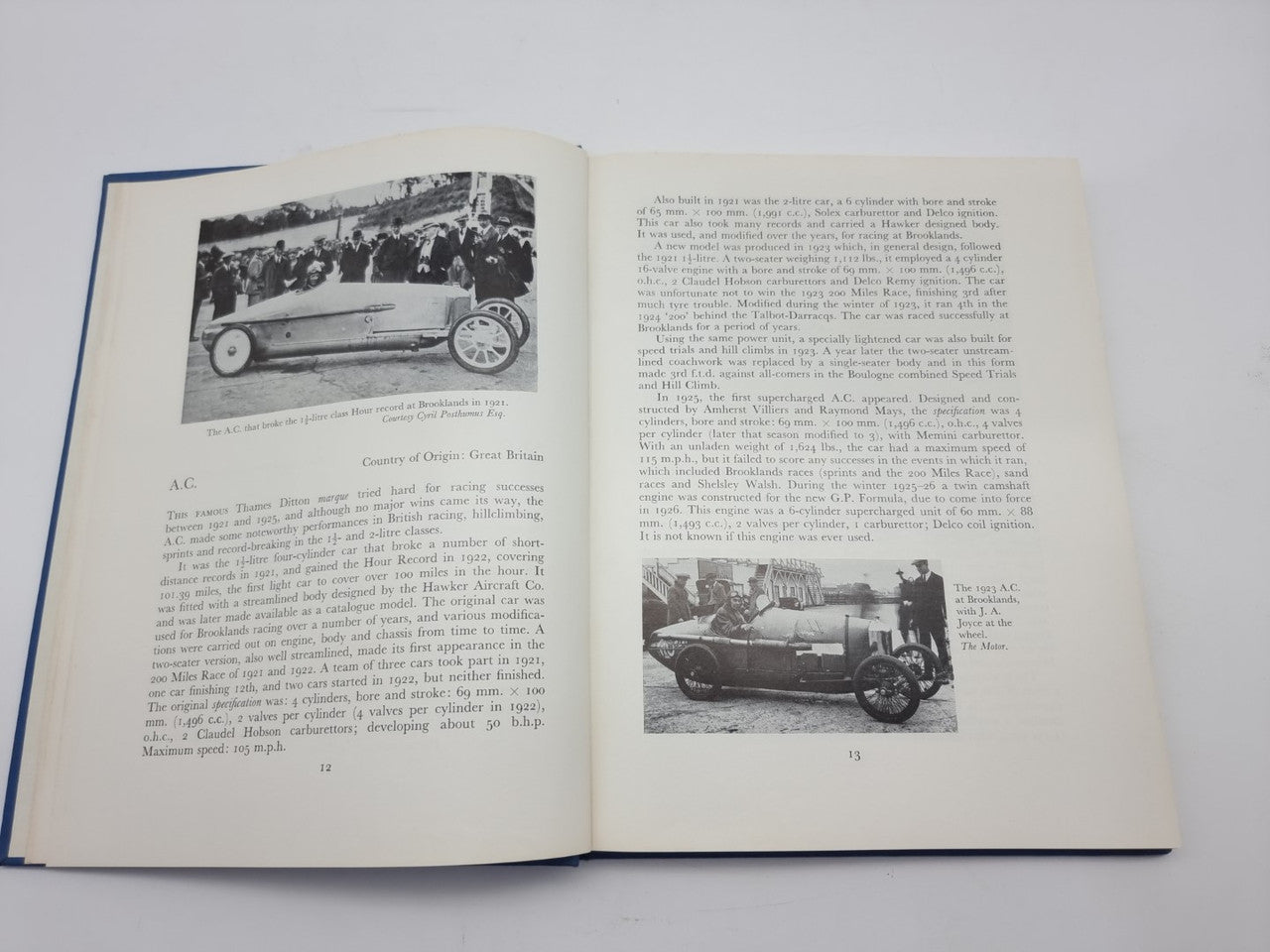 Open book spread with black-and-white race car photos and caption text