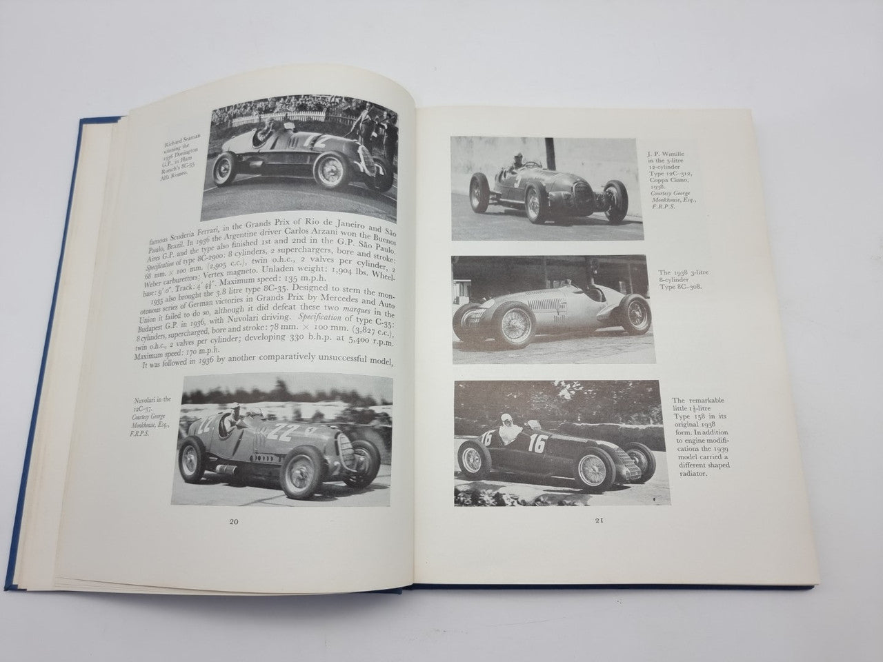 Open book spread with multiple black-and-white race car photos and captions