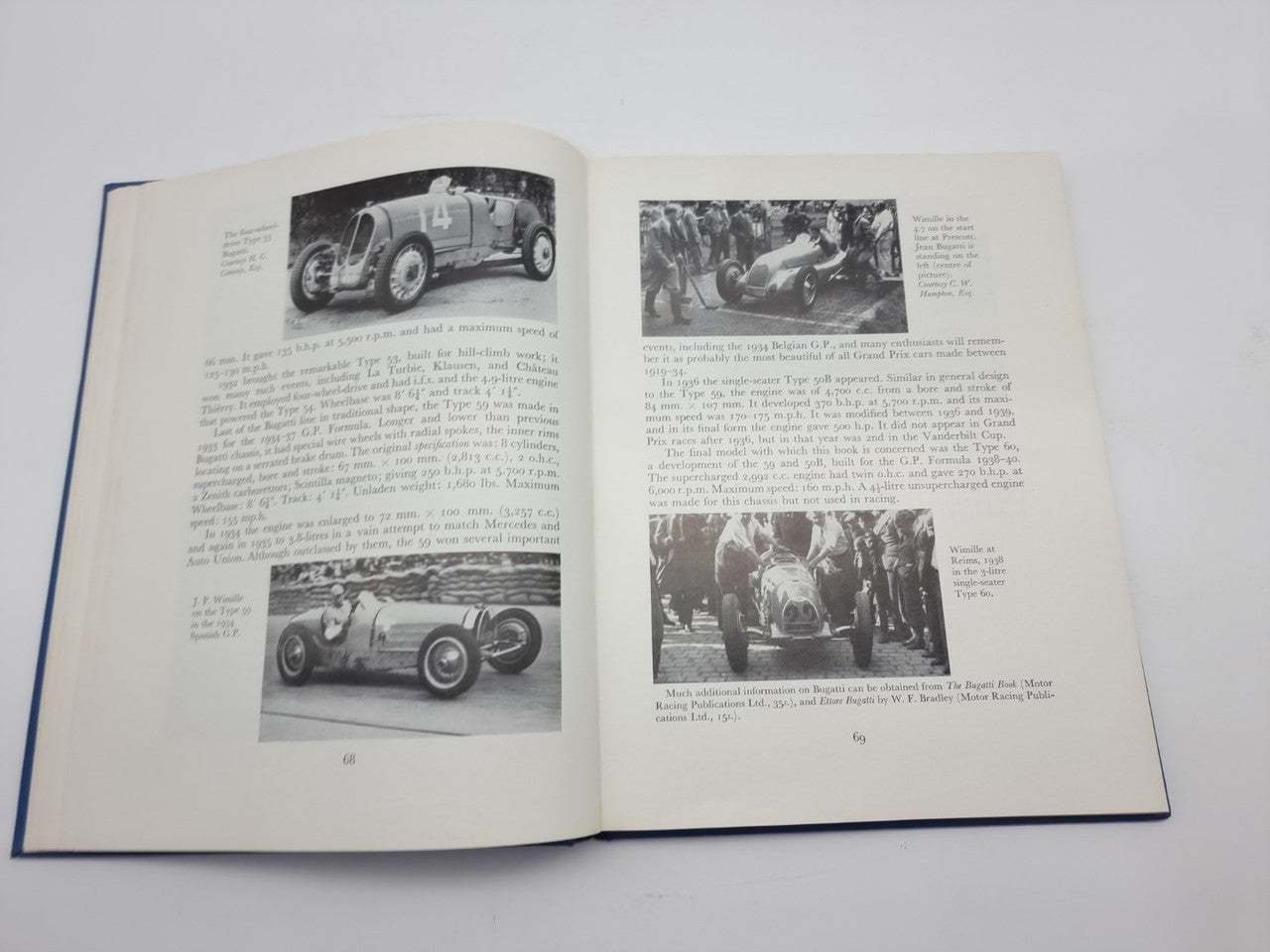 Open racing cars history book showing multiple vintage race car photos and paragraphs