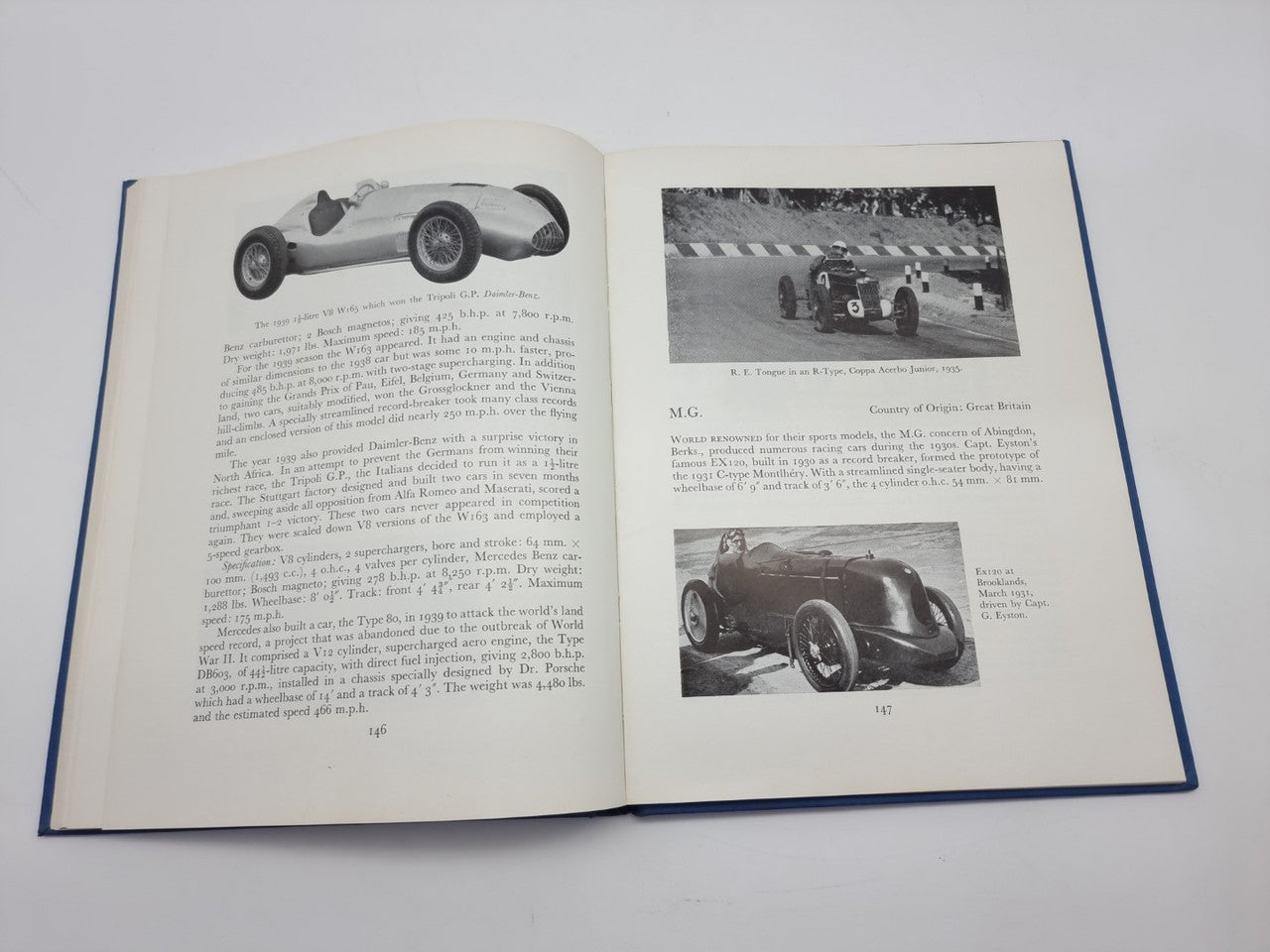 Open racing cars history book with car profile photo and track car photo