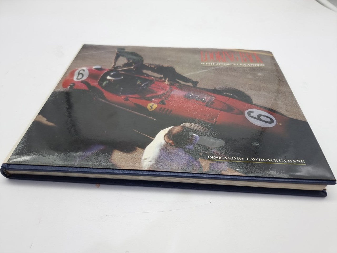 Signed hardcover book with classic race car photo on the cover