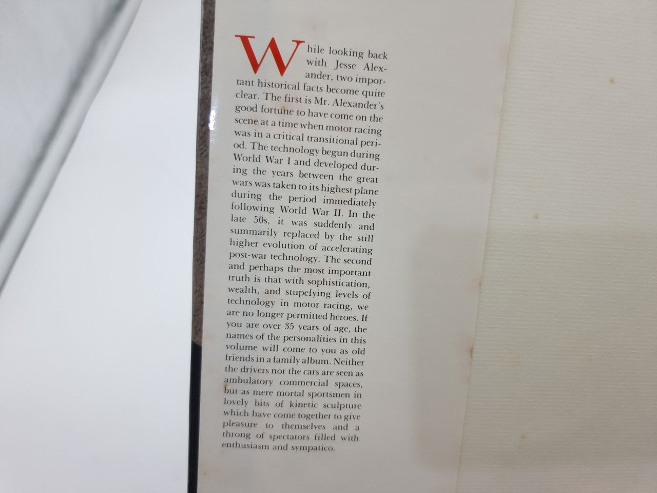 Single book page with red logo and dense vertical text column